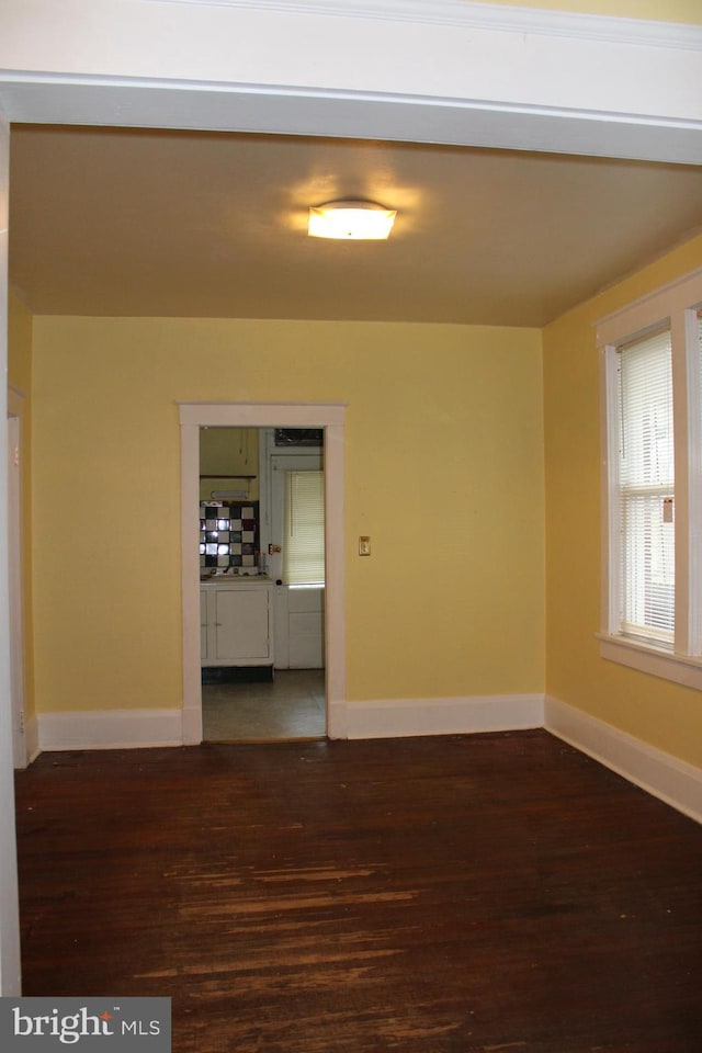 empty room featuring dark wood-type flooring