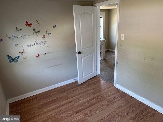 empty room with hardwood / wood-style floors