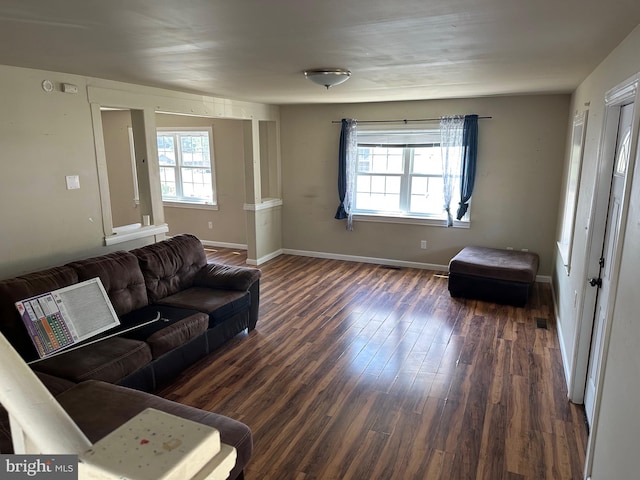 living room with dark hardwood / wood-style flooring