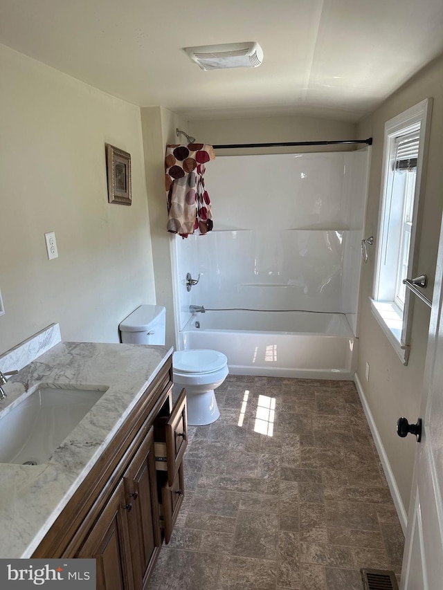 full bathroom featuring tile floors, vaulted ceiling, toilet, vanity, and shower / bathing tub combination