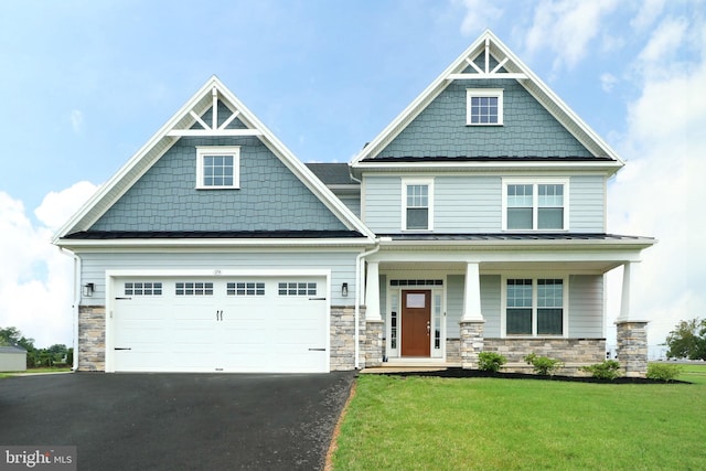 craftsman inspired home with a porch and a front yard