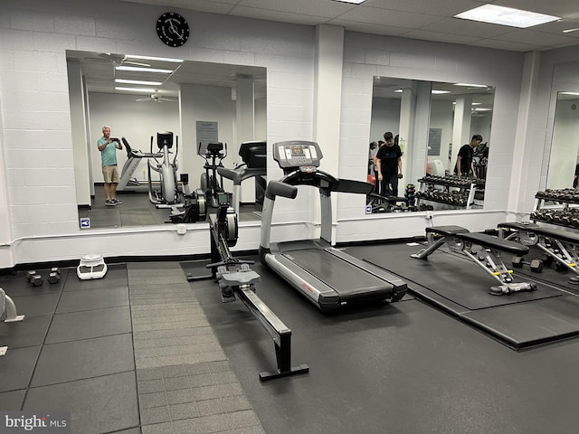 gym with a paneled ceiling