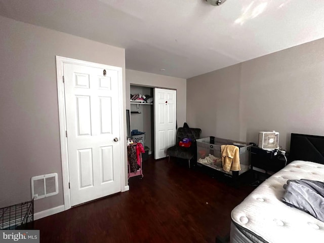 bedroom featuring a closet and dark wood-type flooring