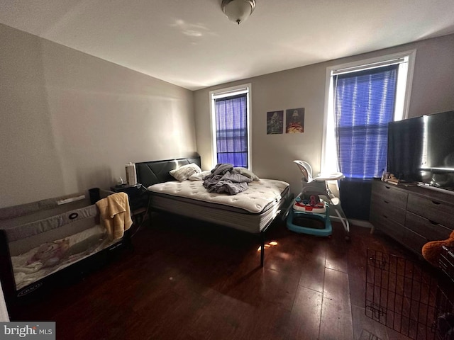 bedroom with dark wood-type flooring