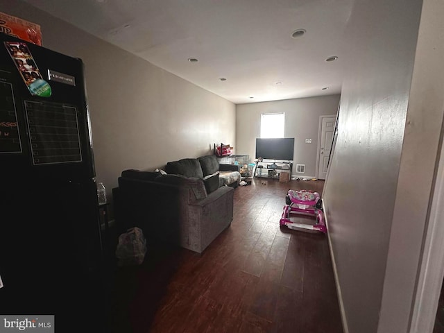 living room featuring dark wood-type flooring