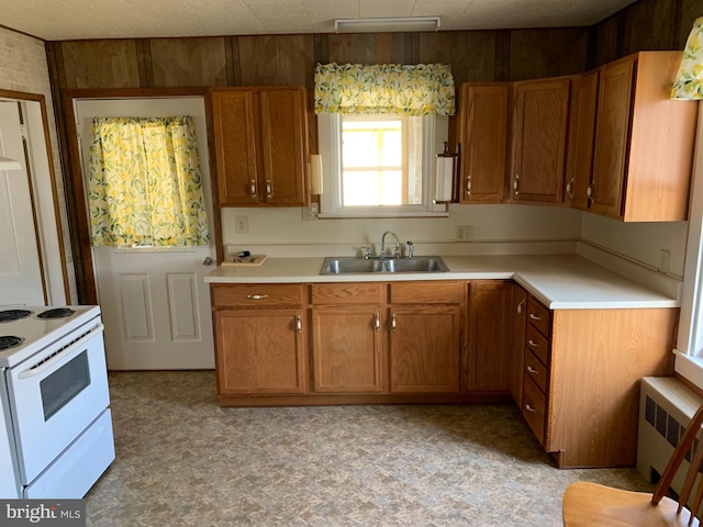 kitchen featuring white range with electric stovetop, light tile flooring, sink, and radiator heating unit