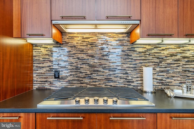 kitchen with tasteful backsplash and stainless steel gas cooktop