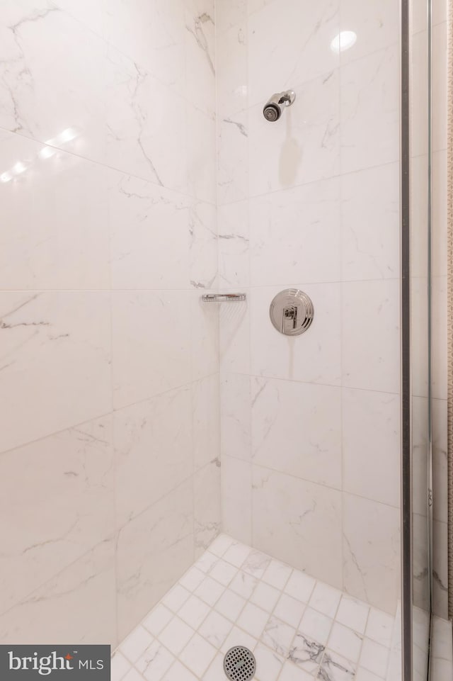 bathroom with tiled shower