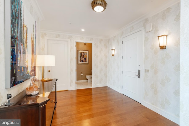 hall featuring crown molding and light wood-type flooring