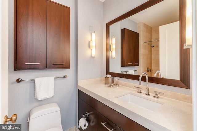 bathroom featuring large vanity and toilet