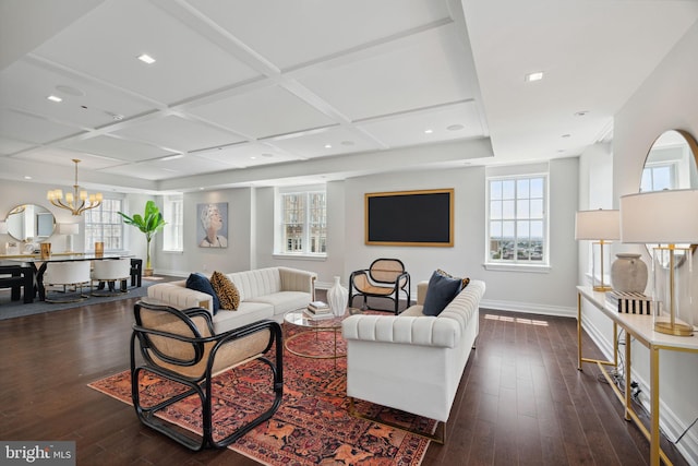 living room with an inviting chandelier, dark hardwood / wood-style flooring, and coffered ceiling