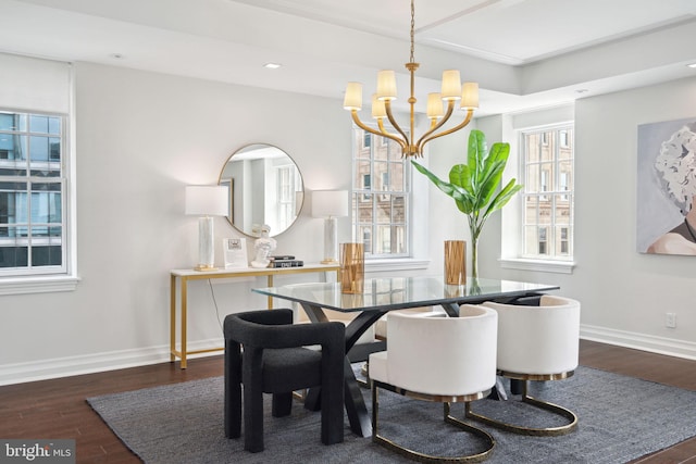 dining area with an inviting chandelier and dark hardwood / wood-style flooring