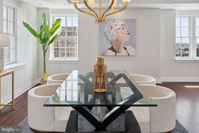 dining room with dark hardwood / wood-style floors and a notable chandelier