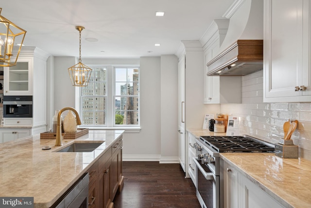 kitchen with black oven, backsplash, white cabinetry, and stainless steel range