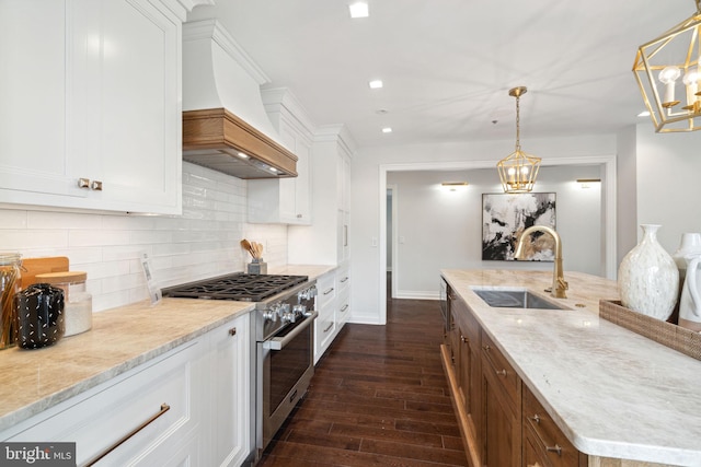 kitchen featuring white cabinetry, high end range, and tasteful backsplash