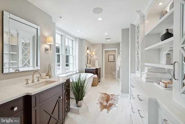 bathroom with tile flooring, vanity, and a bidet