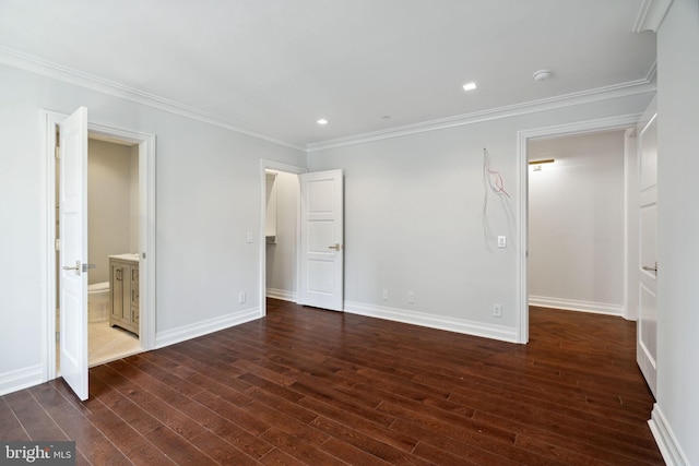 unfurnished bedroom featuring connected bathroom, dark hardwood / wood-style flooring, and ornamental molding