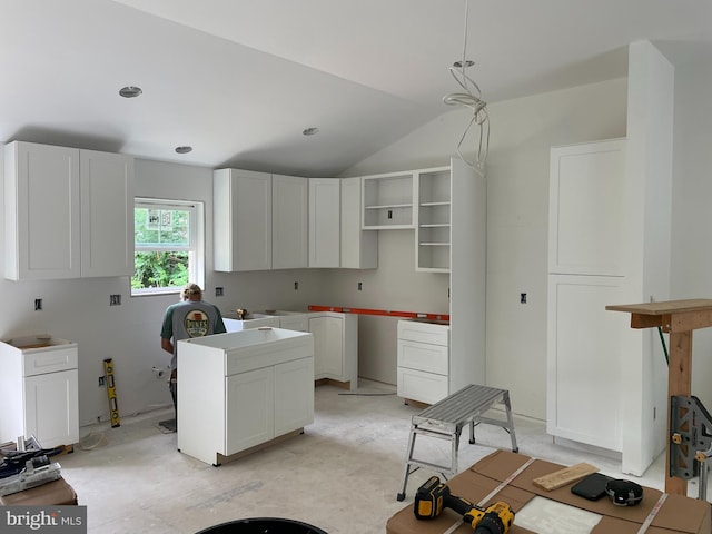 kitchen featuring decorative light fixtures and white cabinetry