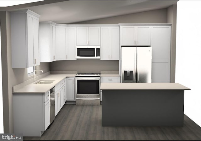 kitchen with dark hardwood / wood-style flooring, appliances with stainless steel finishes, white cabinetry, sink, and vaulted ceiling