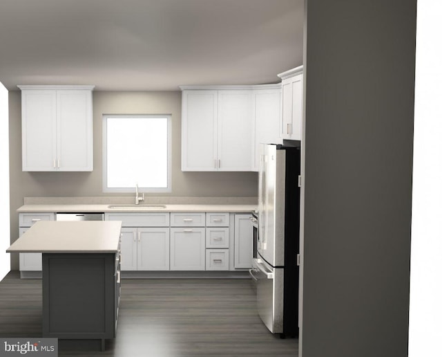 kitchen with a kitchen island, stainless steel fridge, sink, dark hardwood / wood-style floors, and white cabinets