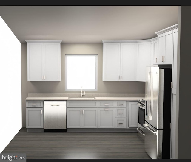 kitchen featuring white cabinets, dark wood-type flooring, appliances with stainless steel finishes, and sink