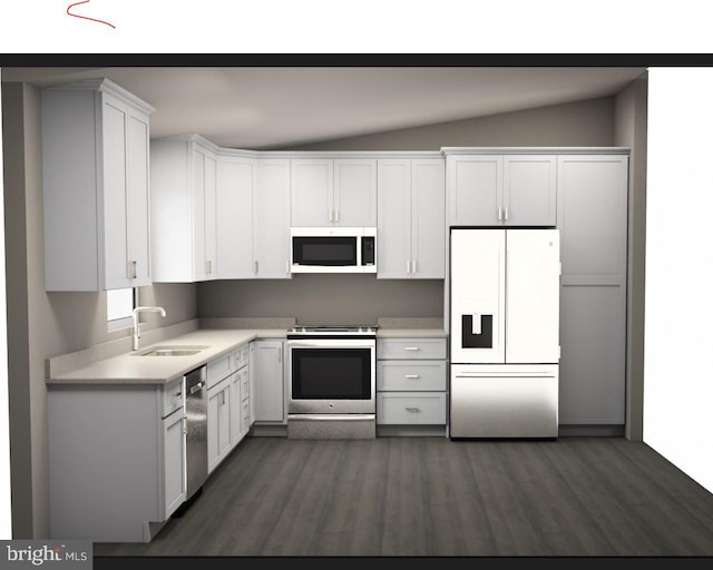 kitchen featuring sink, appliances with stainless steel finishes, dark wood-type flooring, white cabinetry, and lofted ceiling