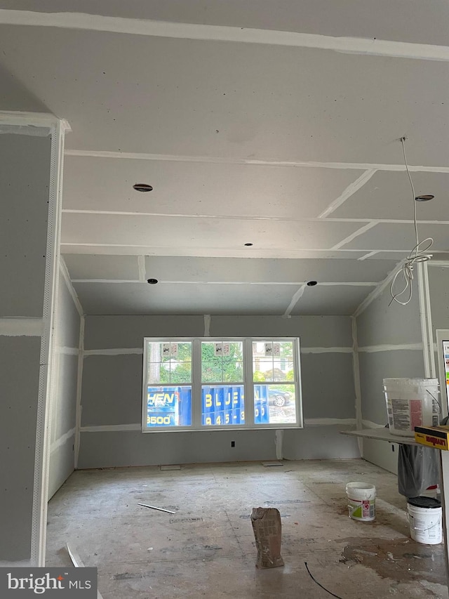 empty room with vaulted ceiling