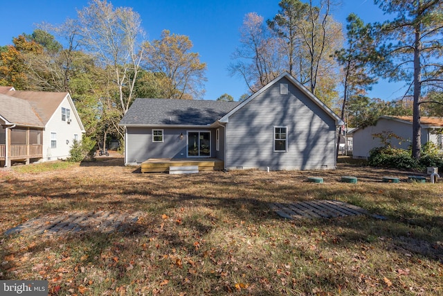 rear view of property with a lawn