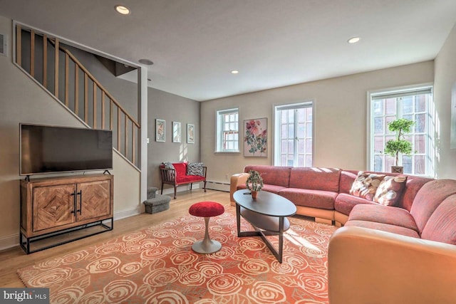 living room featuring light wood-type flooring and baseboard heating