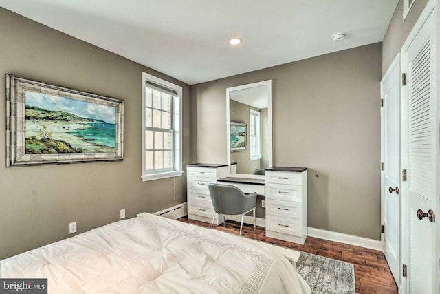 bedroom featuring dark hardwood / wood-style flooring and a baseboard radiator