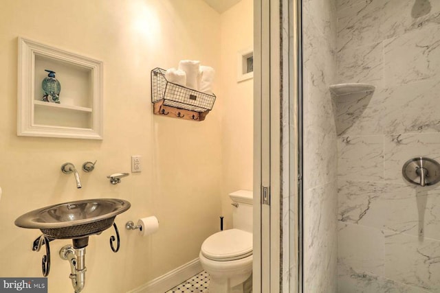 bathroom with toilet and tile floors