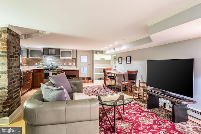 living room with light hardwood / wood-style flooring and brick wall