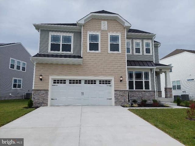 view of front of property featuring a front yard, a garage, and central AC unit