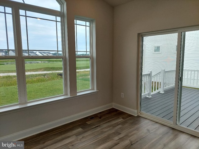 unfurnished room with dark wood-type flooring