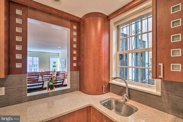 kitchen with sink and light stone counters