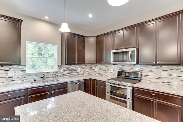 kitchen featuring tasteful backsplash, stainless steel appliances, and sink