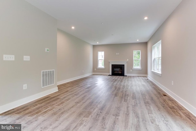 unfurnished living room featuring light hardwood / wood-style floors