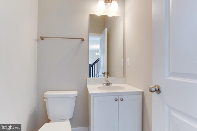 bathroom with toilet and large vanity