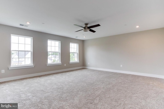 spare room featuring ceiling fan and light colored carpet