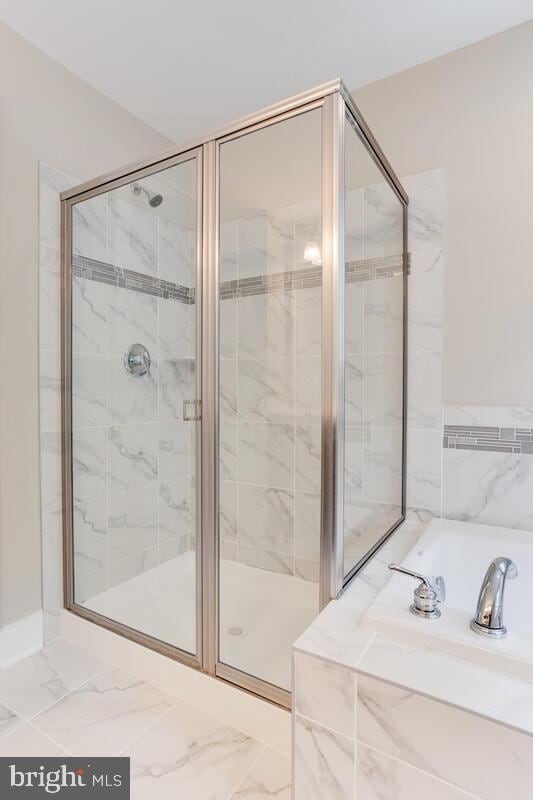 bathroom with separate shower and tub and tile floors