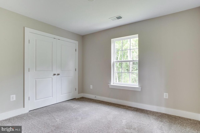 unfurnished bedroom featuring light colored carpet