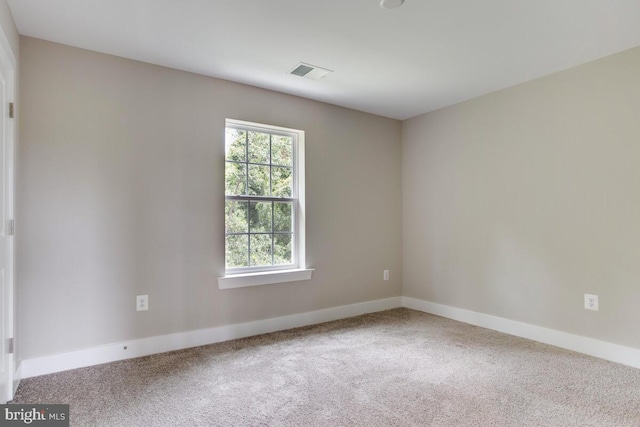 empty room featuring light carpet