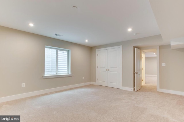 interior space with light carpet and a closet