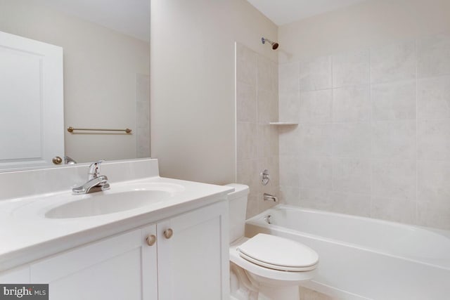 full bathroom featuring large vanity, toilet, and tiled shower / bath