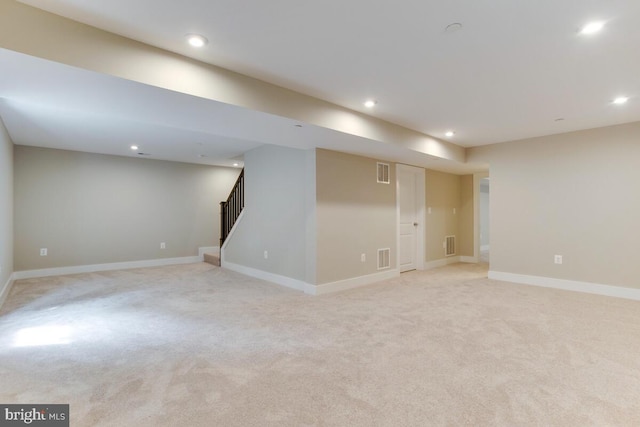 basement featuring light carpet