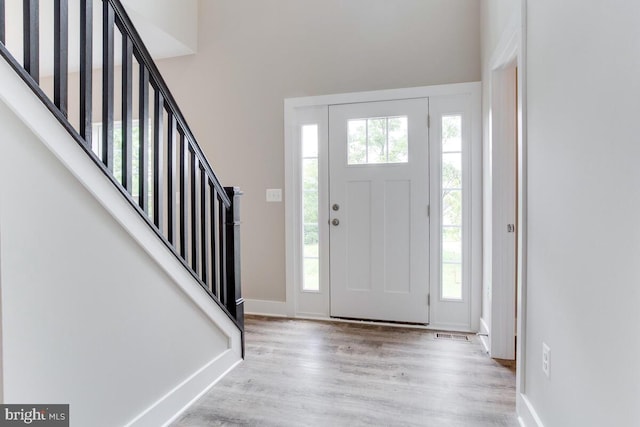 entryway with plenty of natural light and light hardwood / wood-style flooring