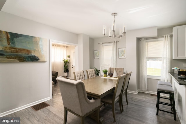 dining space featuring a chandelier and dark hardwood / wood-style flooring