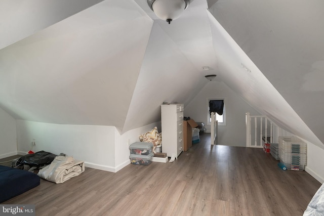 bonus room with lofted ceiling and wood-type flooring