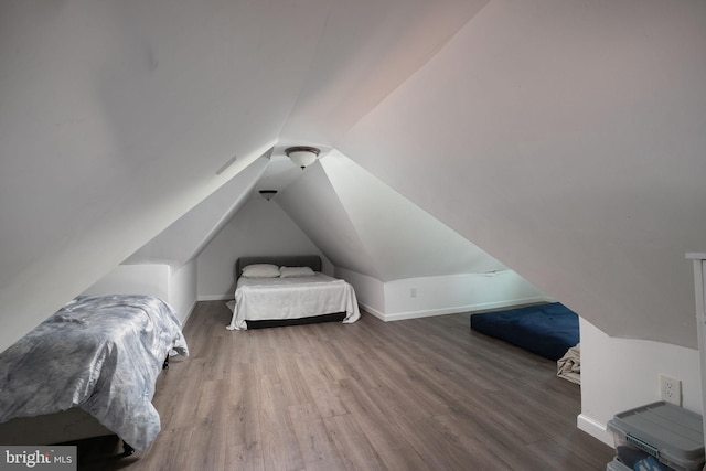 bedroom featuring lofted ceiling and dark hardwood / wood-style floors