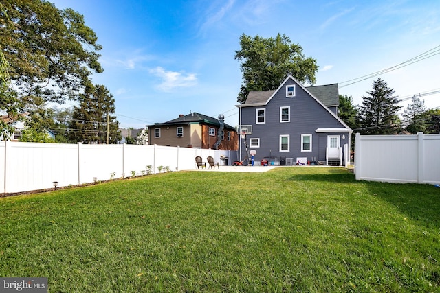 rear view of property featuring a lawn and a patio